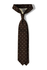 Brown polka dot shantung silk tie, tied in a knot.