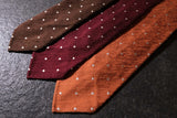 Brown polka dot shantung silk tie shown in a styled mood image.