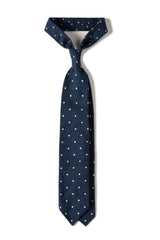 Navy polka dot shantung silk tie, tied in a knot.