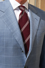 Model wearing the bordeaux striped grenadine shantung silk tie in a tailored look.