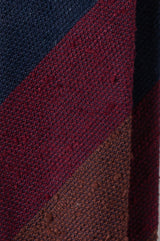 Close-up of the grenadine shantung silk texture with bordeaux, navy and brown stripes.