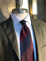 Bordeaux, navy and brown striped grenadine shantung silk tie displayed on a mannequin.