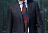 Model wearing the bordeaux, navy and brown striped grenadine shantung silk tie.