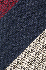 Close-up of the grenadine shantung silk texture with burgundy, navy and beige stripes.