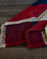 Styled mood image featuring the burgundy, navy and beige striped grenadine shantung silk tie.