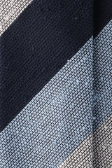 Close-up of the grenadine shantung silk texture with navy, white and light blue stripes.