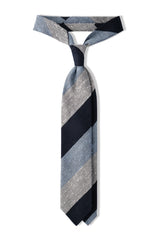 Navy, white and light blue striped grenadine shantung silk tie, tied in a knot.