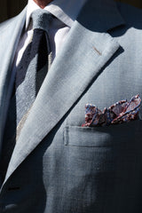 Model wearing the navy, white and light blue striped grenadine shantung silk tie with a coordinating pocket square.