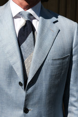 Model wearing the navy, white and light blue striped grenadine shantung silk tie.