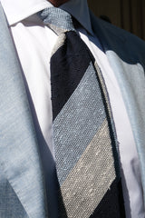 Model wearing the navy, white and light blue striped grenadine shantung silk tie in a tailored look.