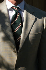 Model wearing the forest, beige and burgundy striped silk shantung tie.
