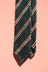 Forest, beige and burgundy striped silk shantung tie shown in a styled mood image.