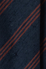 Close-up of the textured silk shantung fabric with navy and brown stripes.