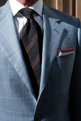 Model wearing the navy and brown striped silk shantung tie with a coordinating pocket square.